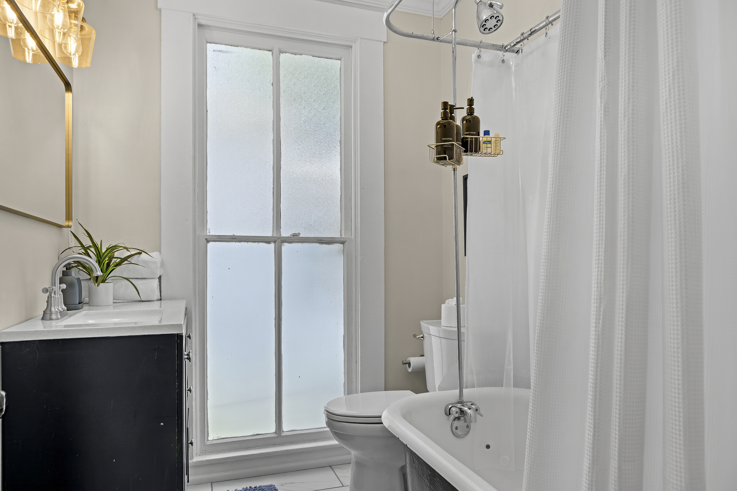 A classic clawfoot tub and clean white finishes. Freshened up and fully stocked for a group stay.