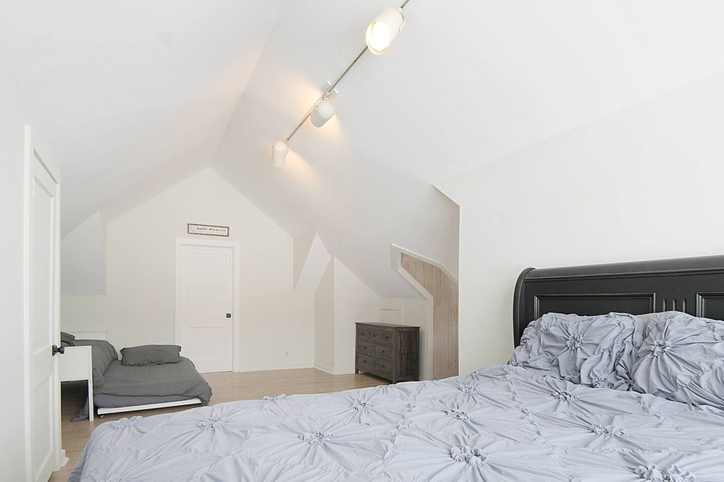Main bedroom of the home boasts a cozy queen bed and a trundle that pulls out for 2 singles! 