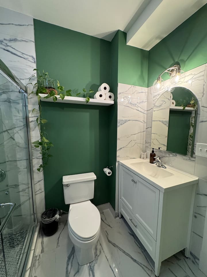 Modern bathroom with stylish green accents and clean finishes.