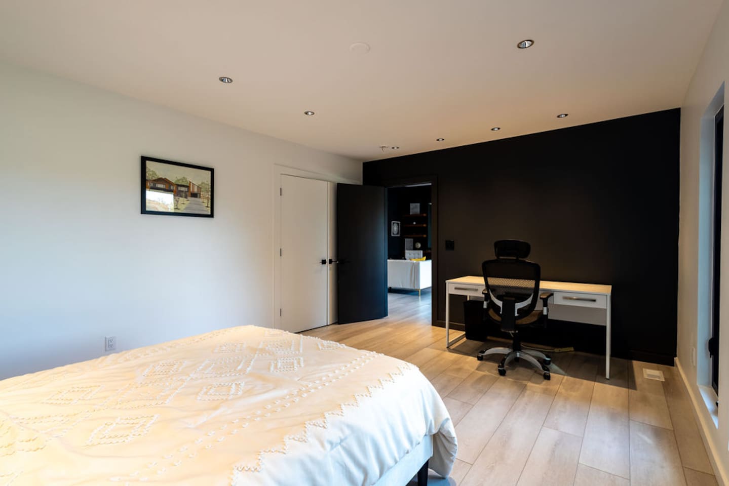 Comfortable bedroom with a dedicated work space, featuring a desk and chair, perfect for those who need to blend relaxation with productivity.