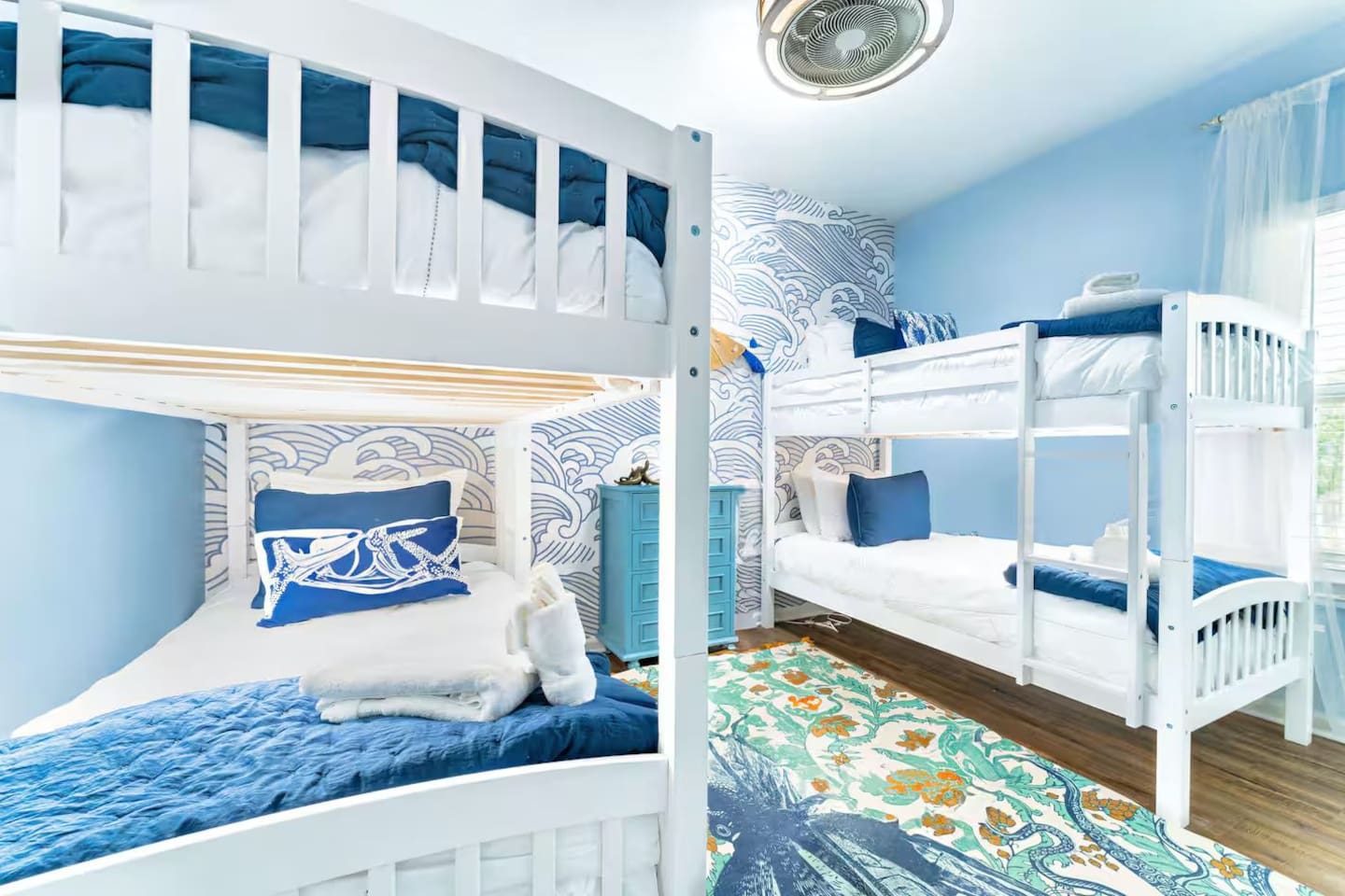 Cozy twin bunk beds provide a comfortable and playful space where kids and friends can relax after a day at the beach