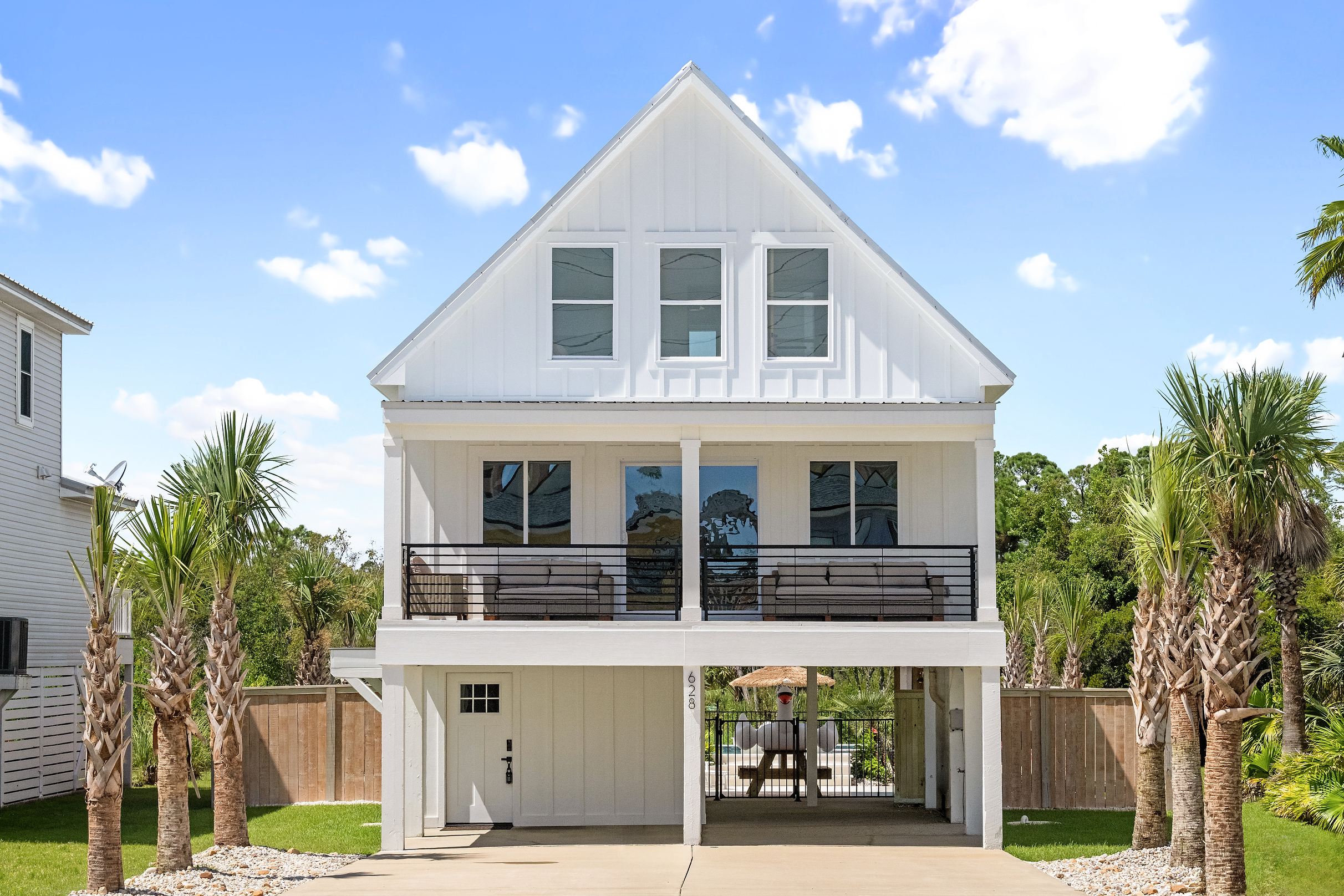 A bright Gulf Shores beach house with covered parking and a spacious front balcony.