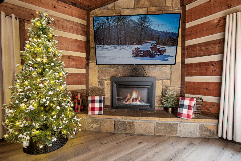 Relax by the fire with beautiful holiday decorations.