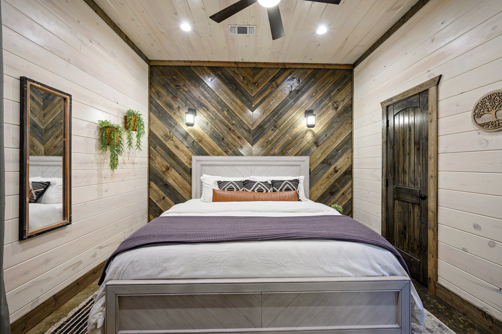 Stunning chevron wood accent wall in a designer king-sized suite.