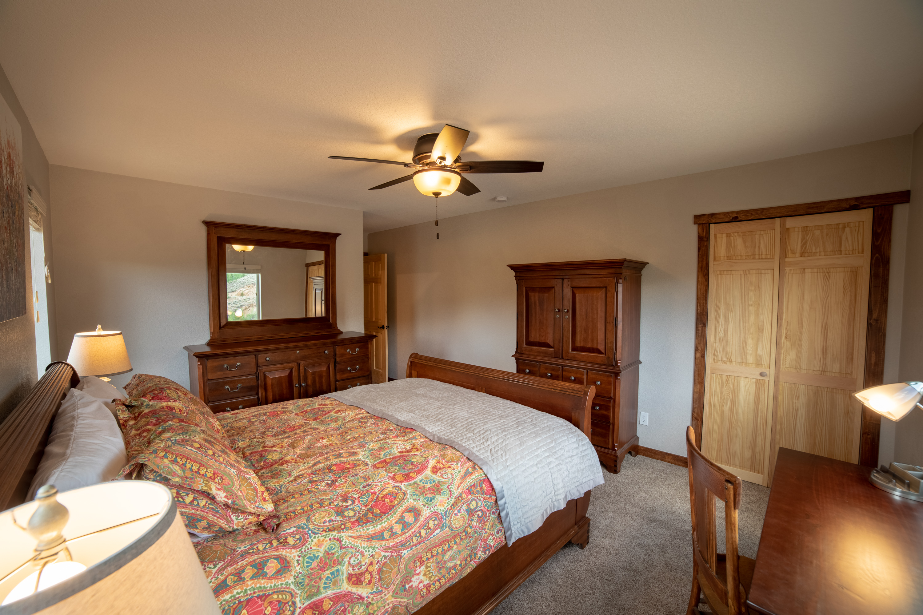 Upstairs Bedroom 3 Spacious queen bedroom featuring a dedicated work desk, ample storage, and elegant high-end furnishings—perfect for both relaxation and productivity during your stay!