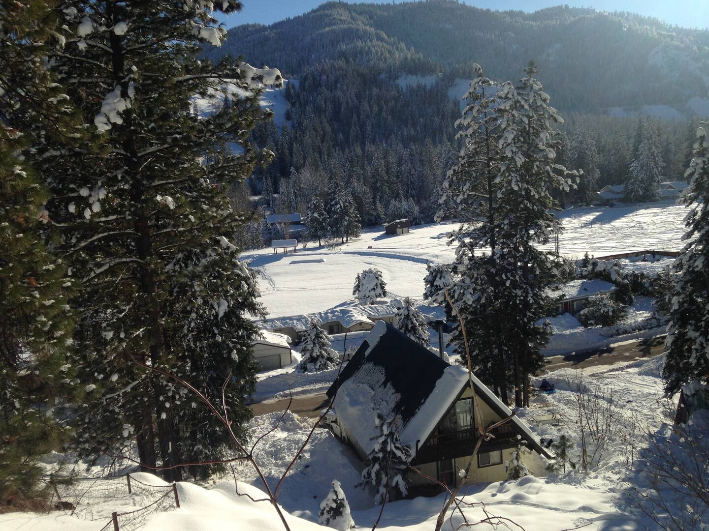Winter wonderland views of the cabin and community pond.