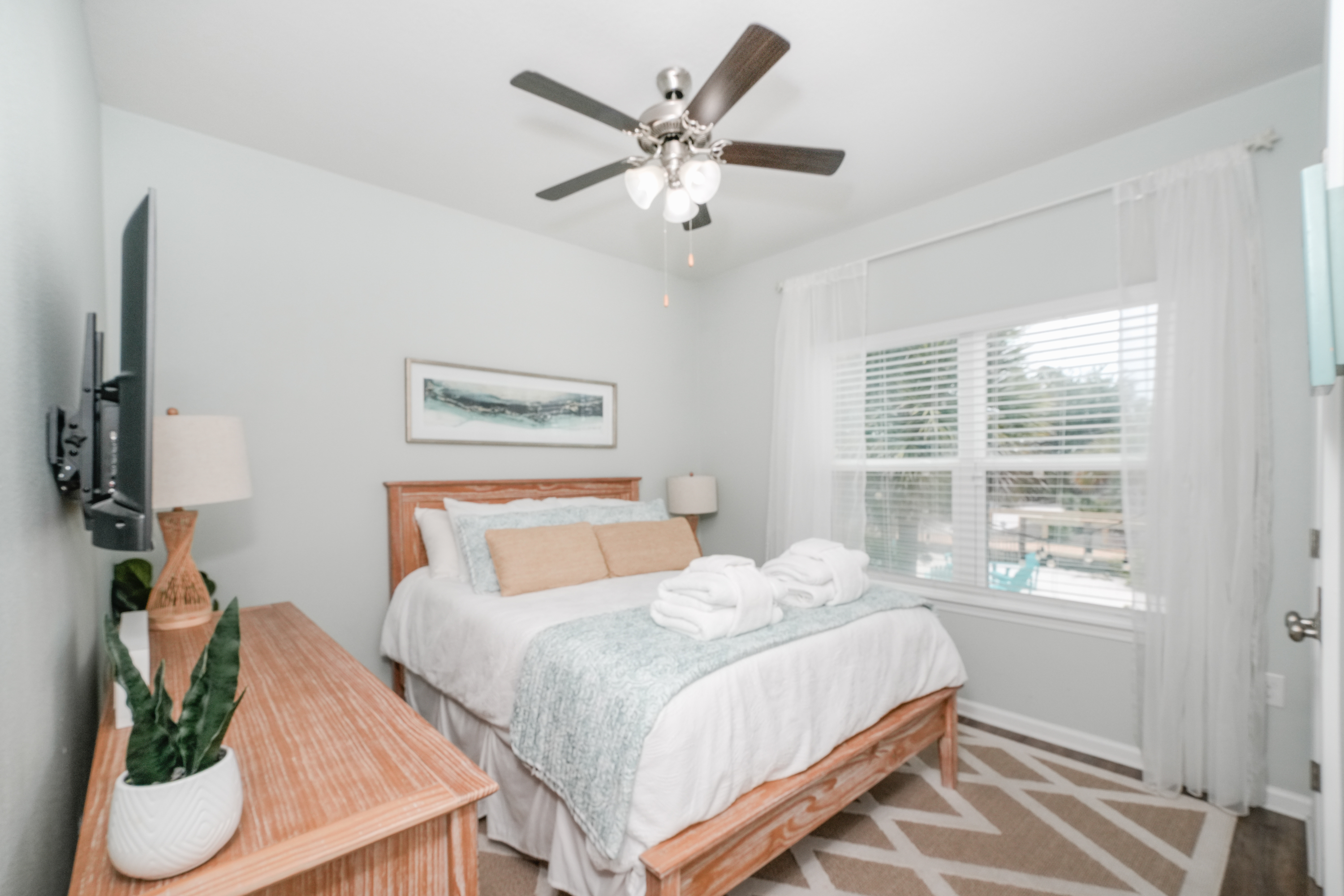 Bedroom 3: Unwind in this inviting queen bedroom featuring soft linens, natural light, and peaceful beach-inspired decor