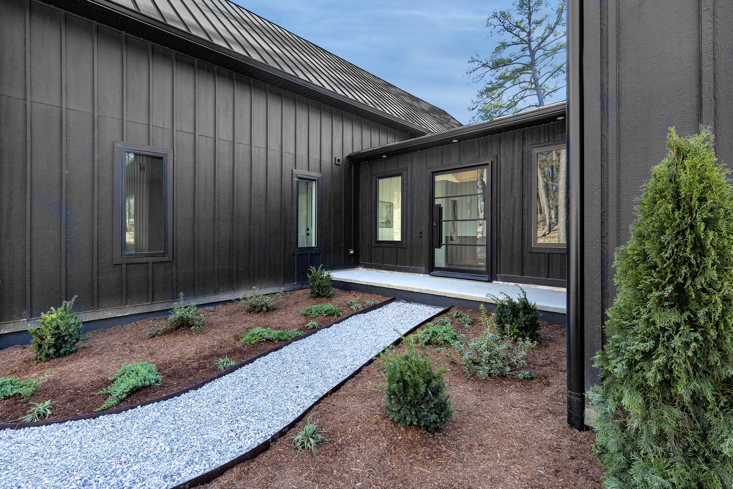 This thoughtfully landscaped entry path leads you through the courtyard and into the heart of your home away from home.