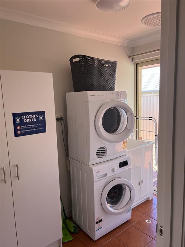 Laundry area with front loading washing machine & clothes dryer