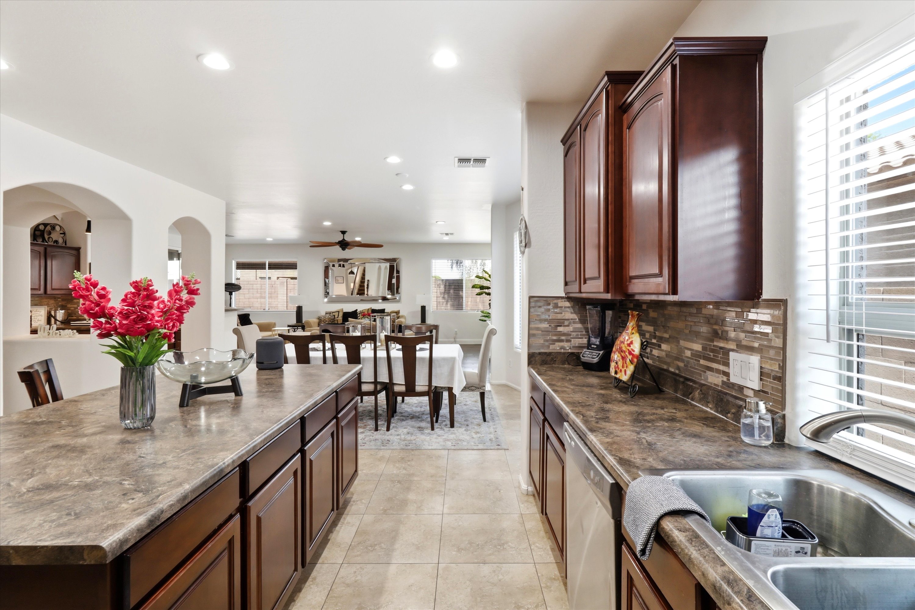 Kitchen view with island seating, full appliances, and the dining and living areas close by.
