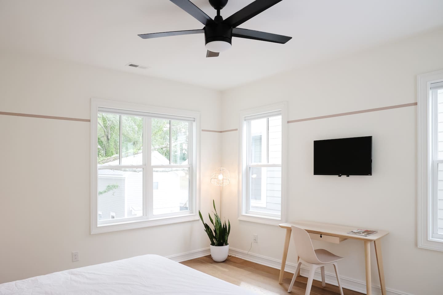 The "rose room" features a queen bed, accents from CB2, a desk for work-from-home, smart TV, a spacious double-door closet and a full bath with a shower tub. 
