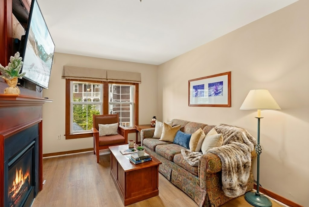 Enjoy the warmth of the fireplace in this spacious living room.