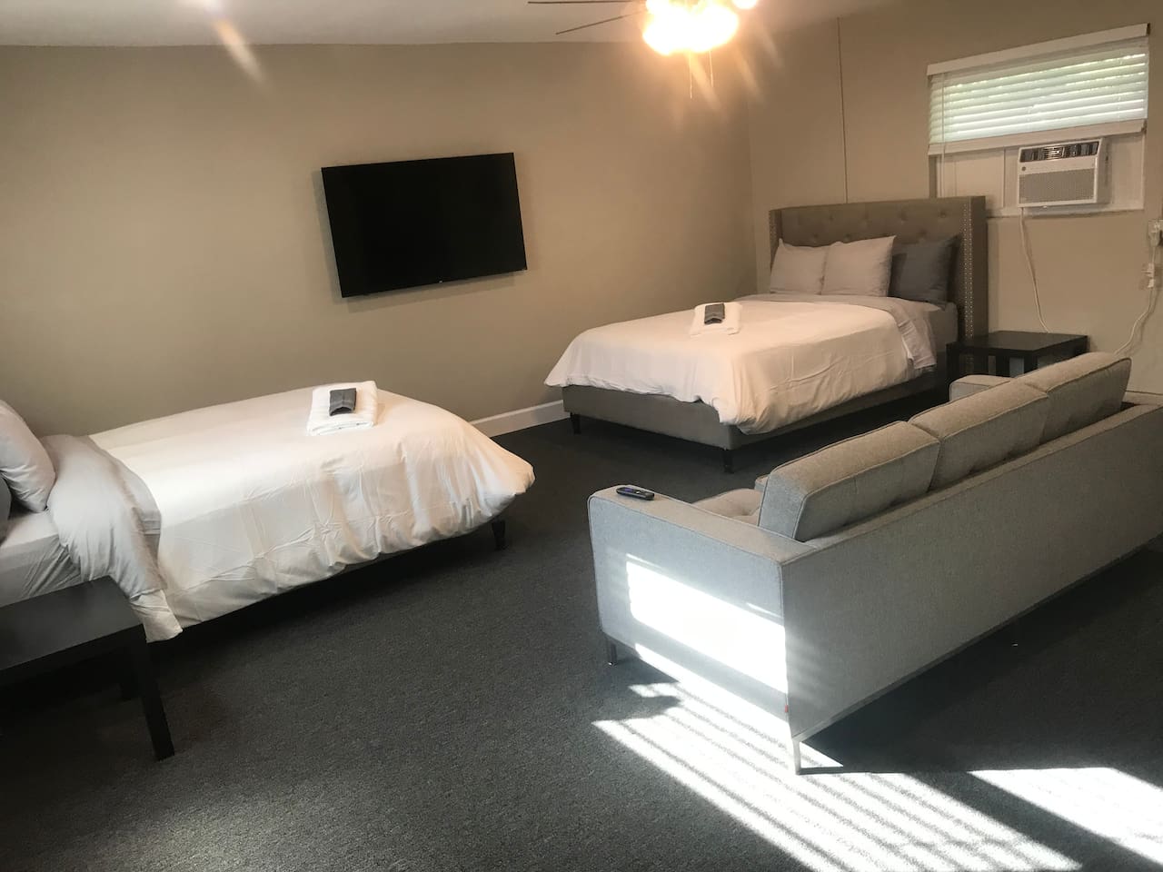Two queen beds with couch, and a 58inch smart TV in the Bonus Room.