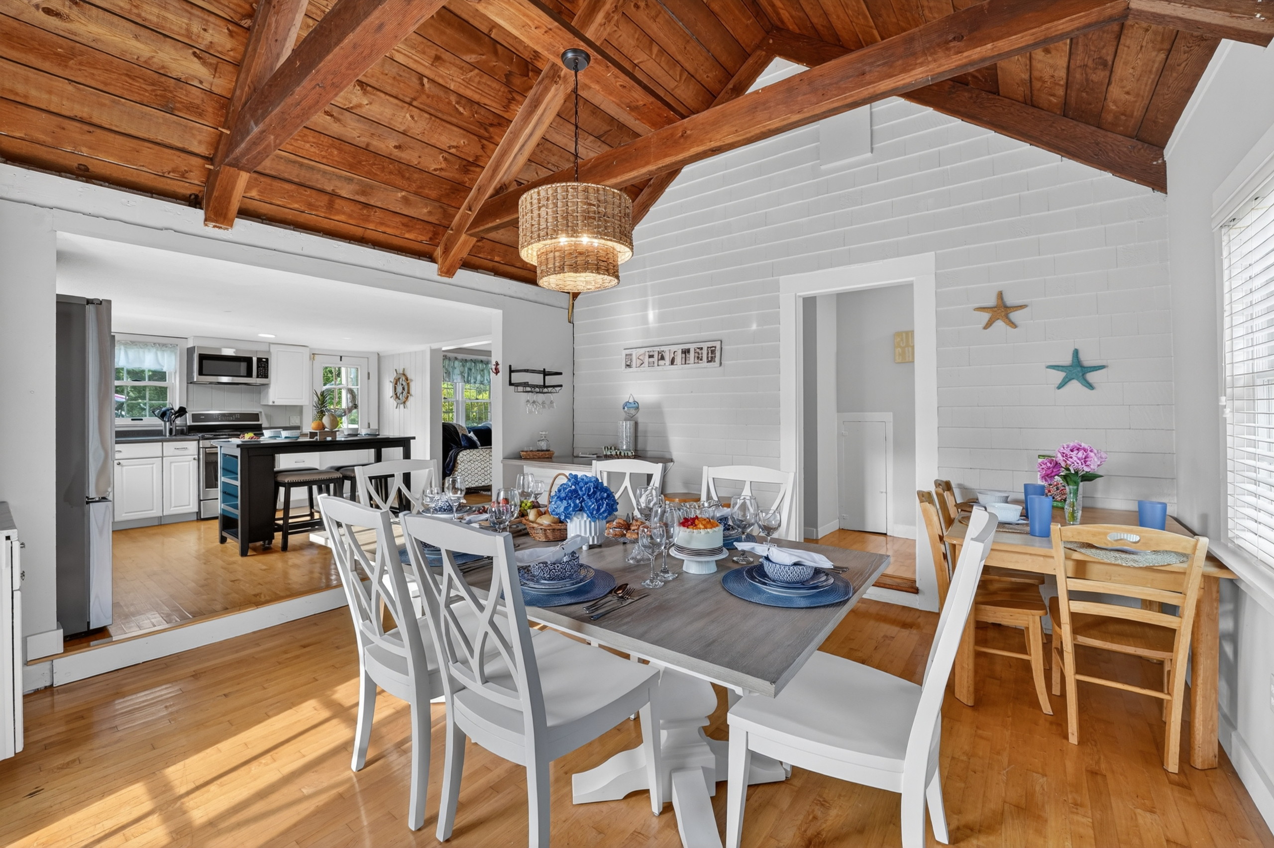 Spacious dining room with seating for the whole group, complemented by warm wood ceilings and coastal charm.