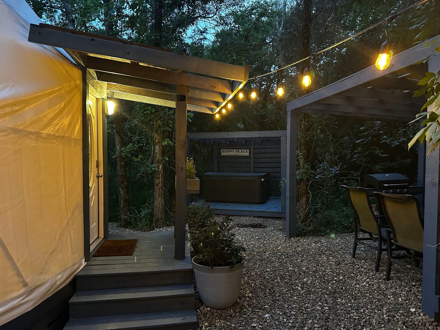 Covered gazebo hot tub with string lights at The Honey Dome
