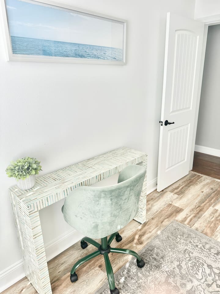 Find a quiet moment at this stylish workspace, with a unique patterned desk and a comfortable velvet swivel chair. Whether you need to catch up on emails or plan your next day's adventure, this bright corner provides a dedicated spot to stay productive.
