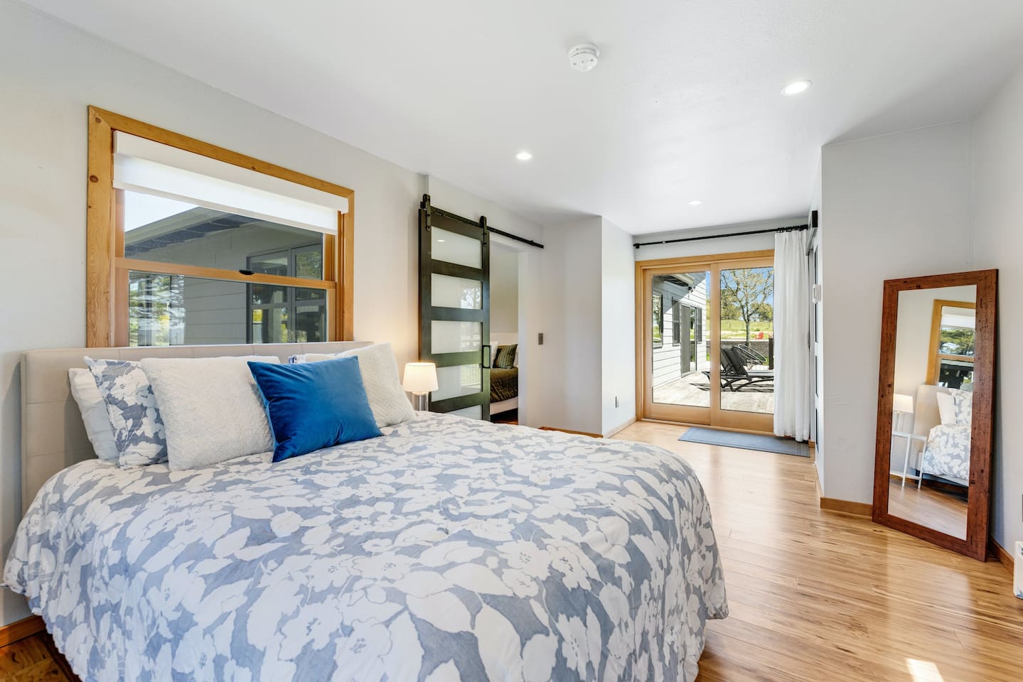 Relaxation meets outdoor charm. Queen-size bed with direct deck access. 