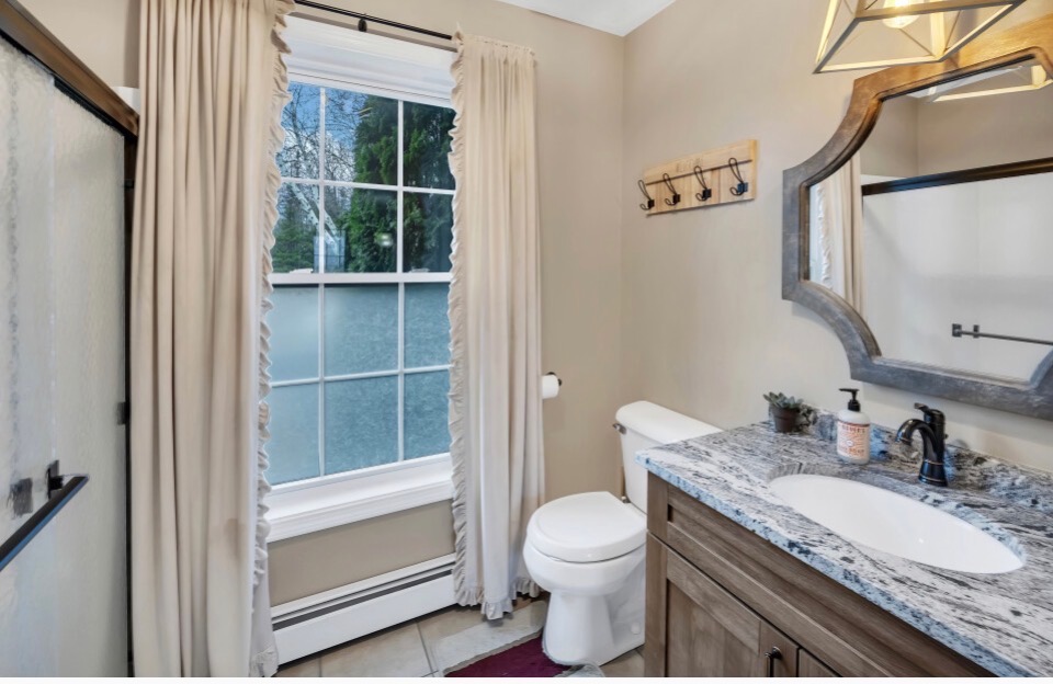 Main Floor Full Bathroom with a step-in shower