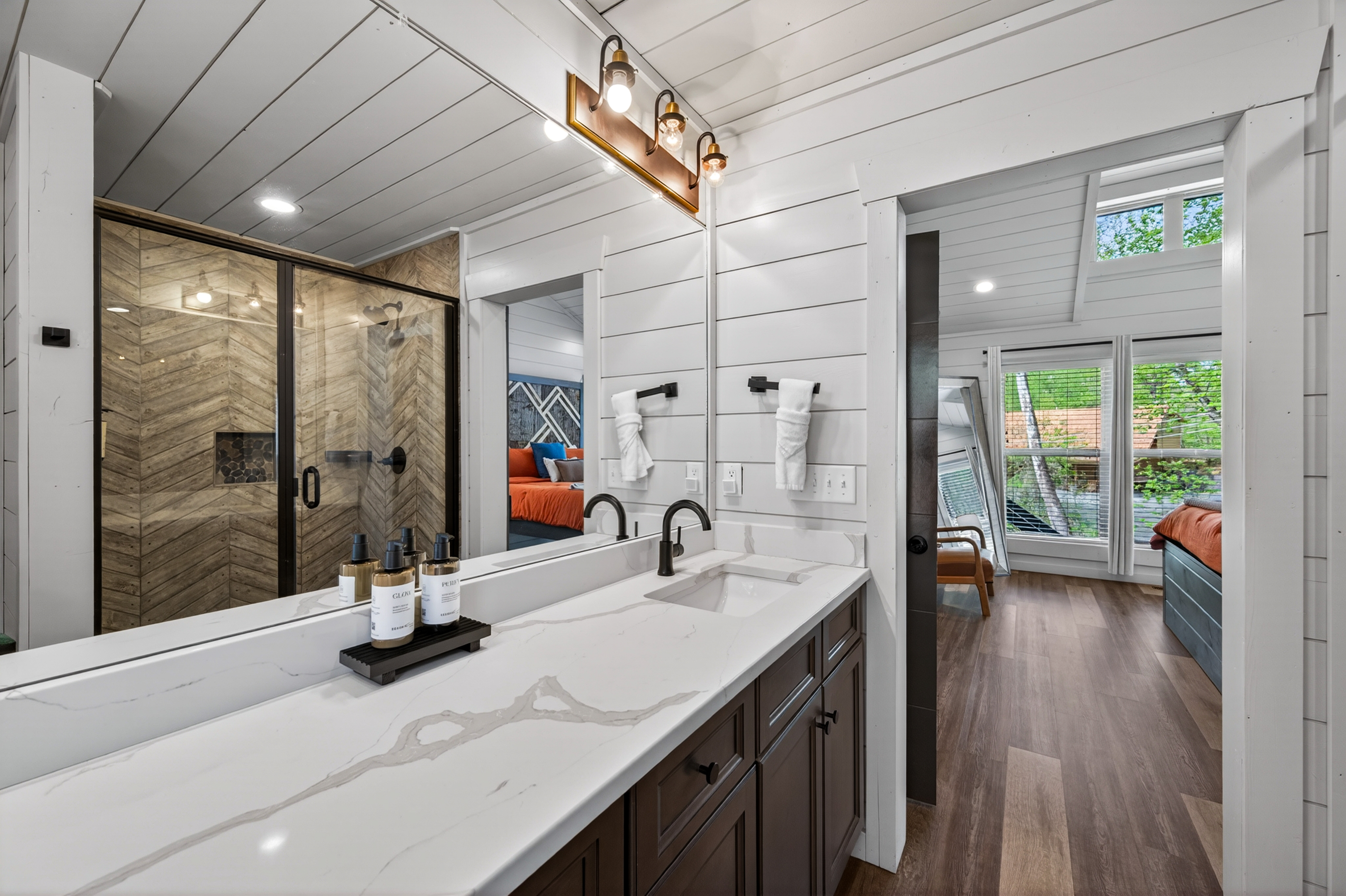 Dual sink vanity and walk-in shower.