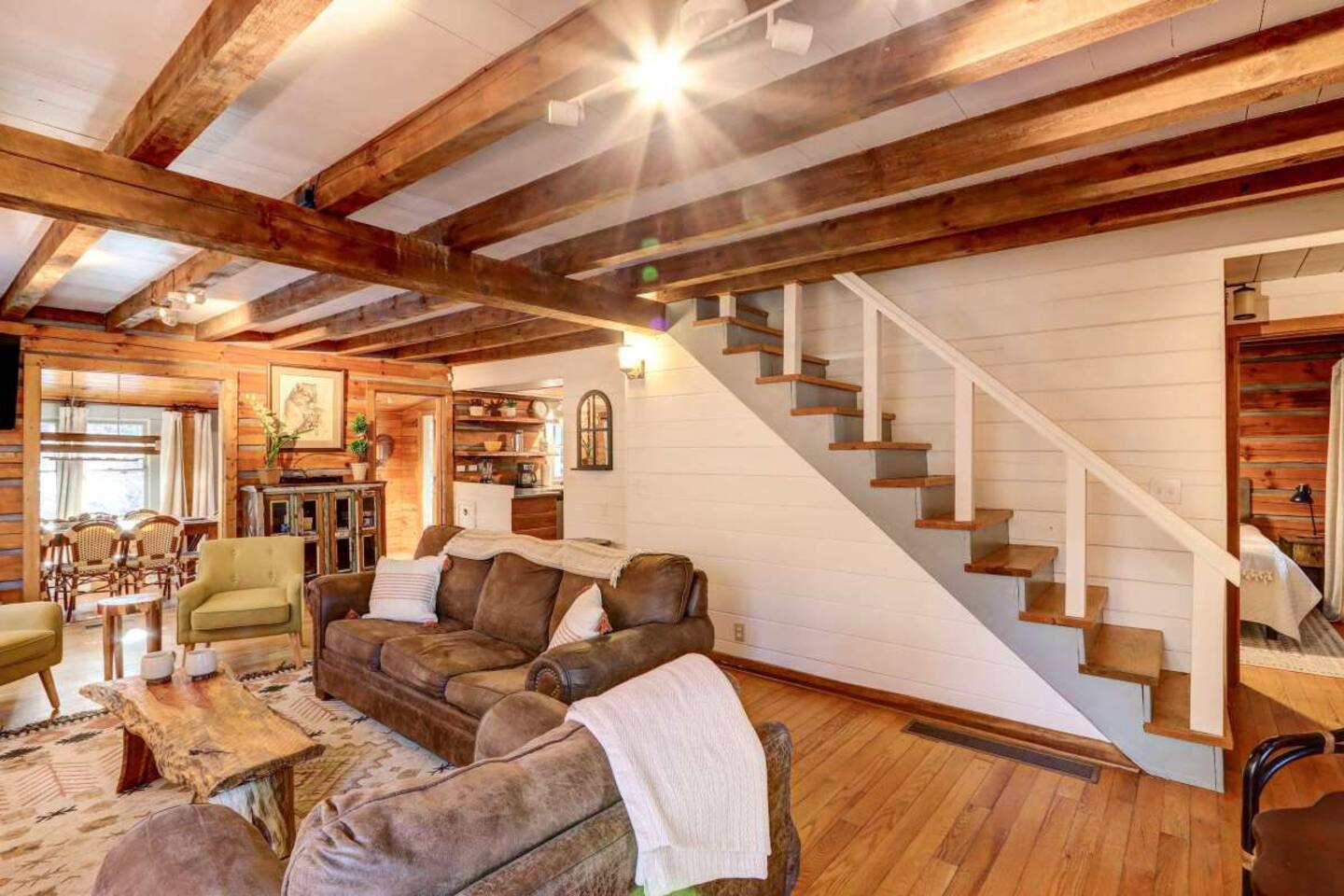 The stairs to the upstairs run along the opposite wall of the fireplace in the living room.  The dining area is viewable and partially walled off from the living room.