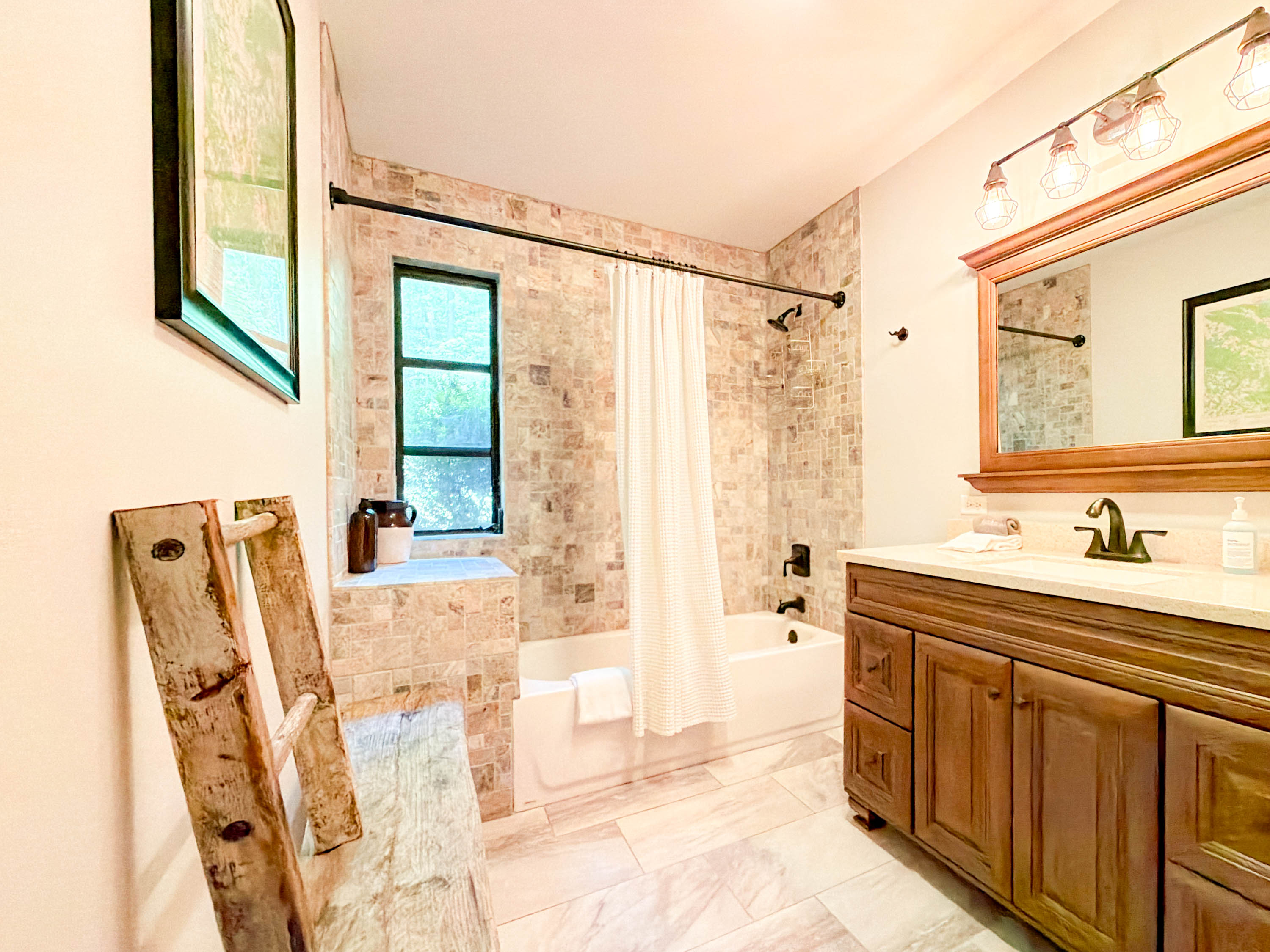 spacious guest bathroom features a tub/shower combo, toilet, and sink.