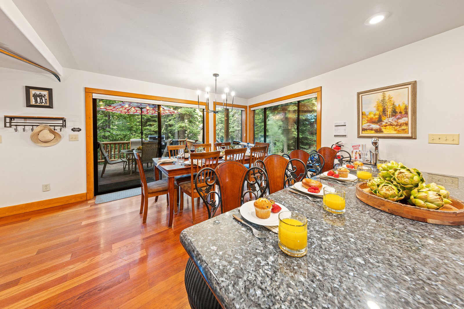 Set out the morning spread and let everyone drift through — the island keeps the kitchen open to the deck and table.