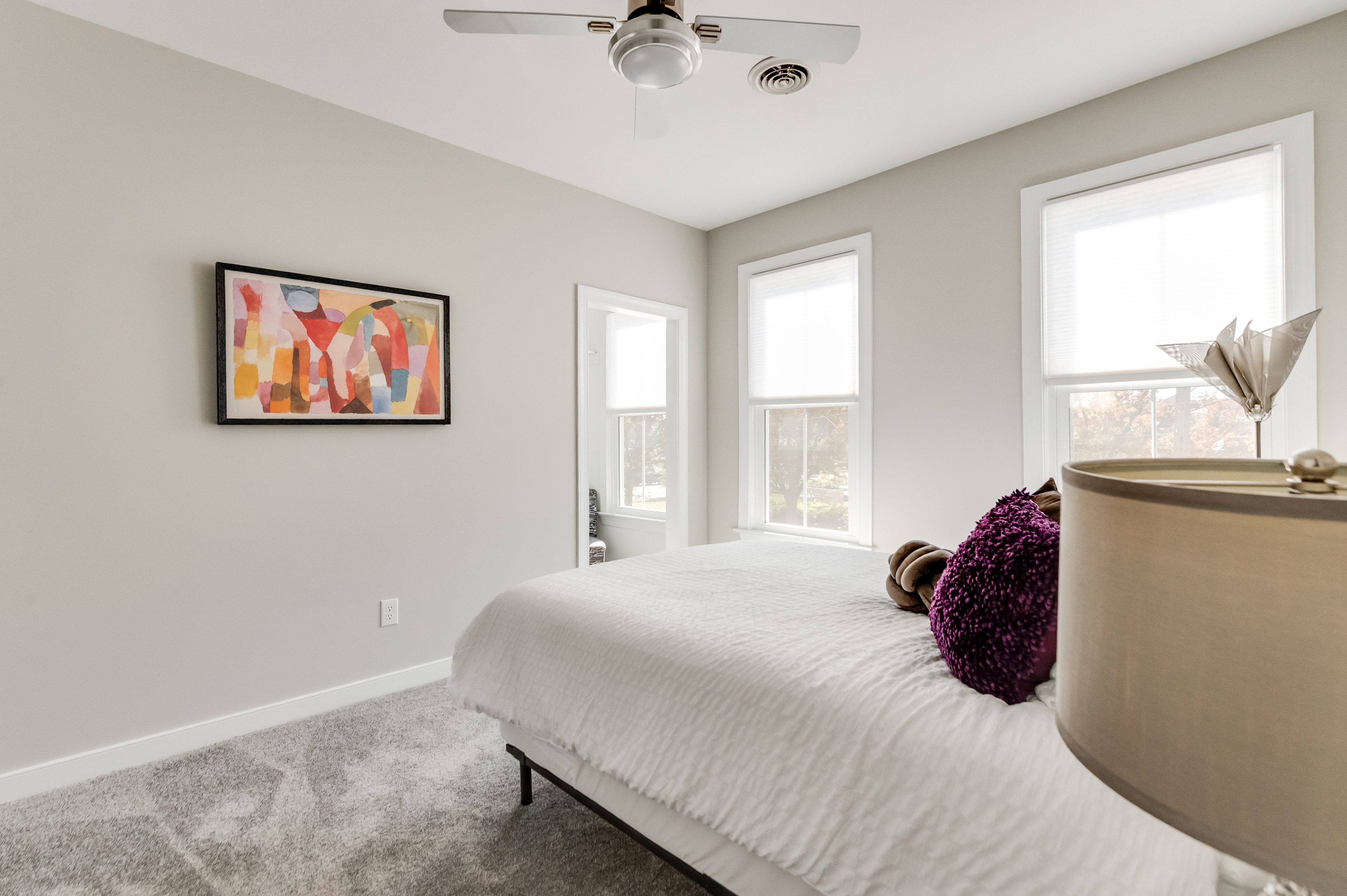 Queen Bedroom 3: Sunlit room with plush textures and vibrant art for ultimate relaxation!