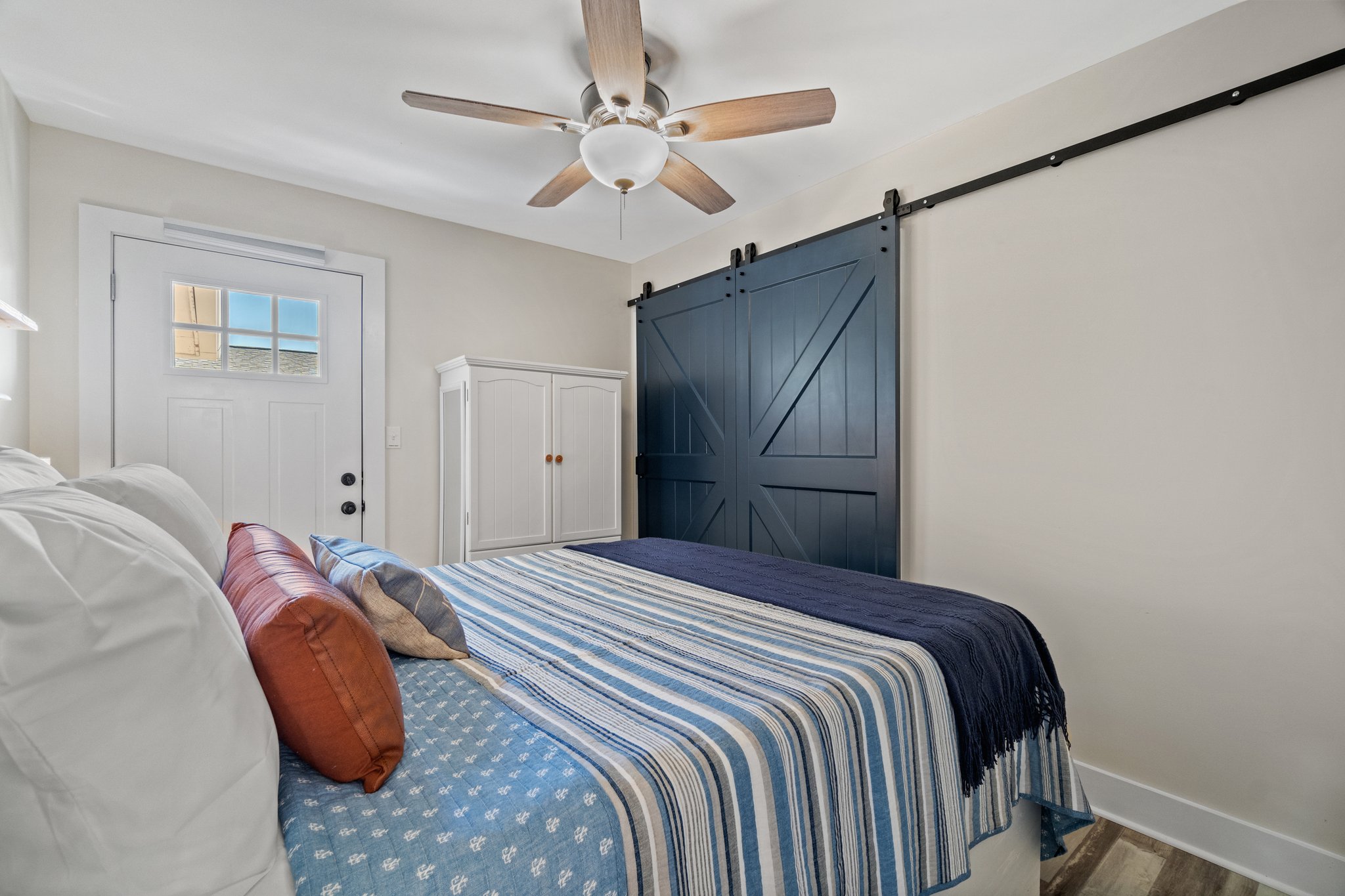 This dreamy beach house bedroom is complete with wardrobe and access to back patio.