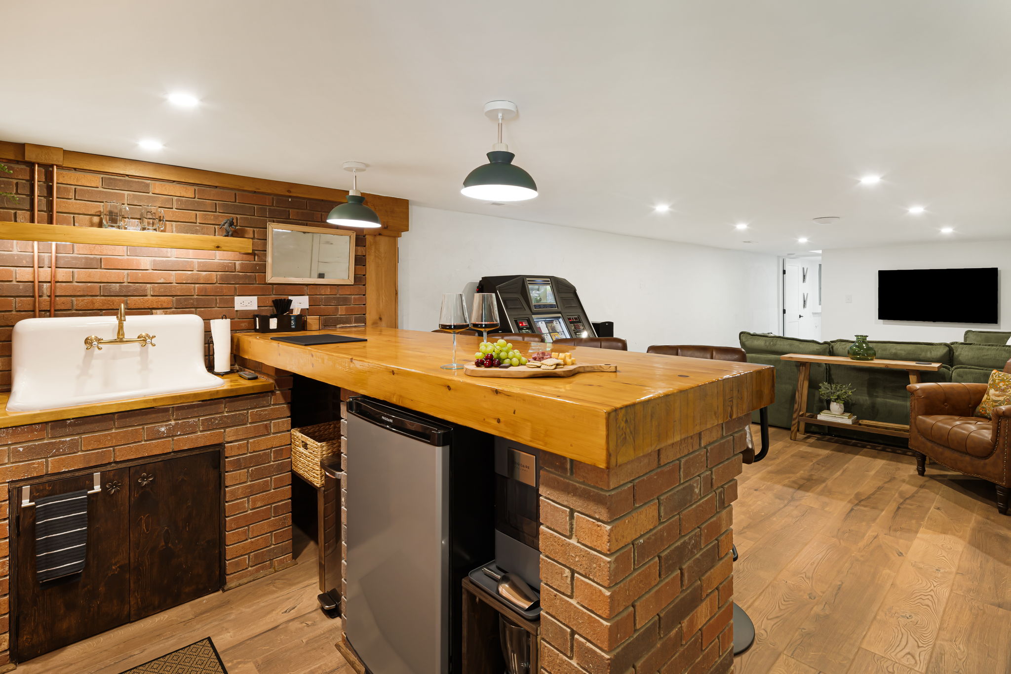 A view of the restored cast iron sink, mini-fridge, ice maker and blender for easy access and convenience.