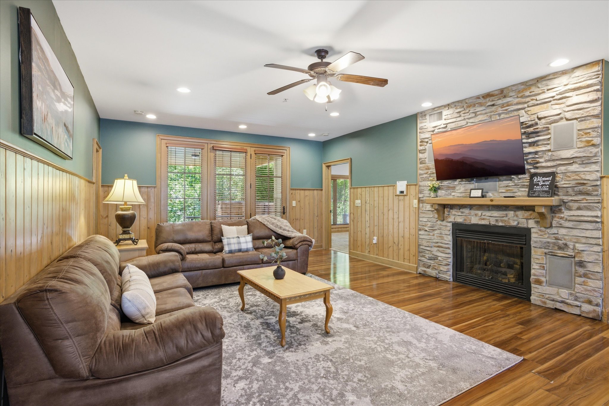 Unwind in the spacious living room with cozy couches, a gas fireplace, and a large TV for movie nights. Step right out to the back porch to enjoy some fresh air and keep the good vibes going.