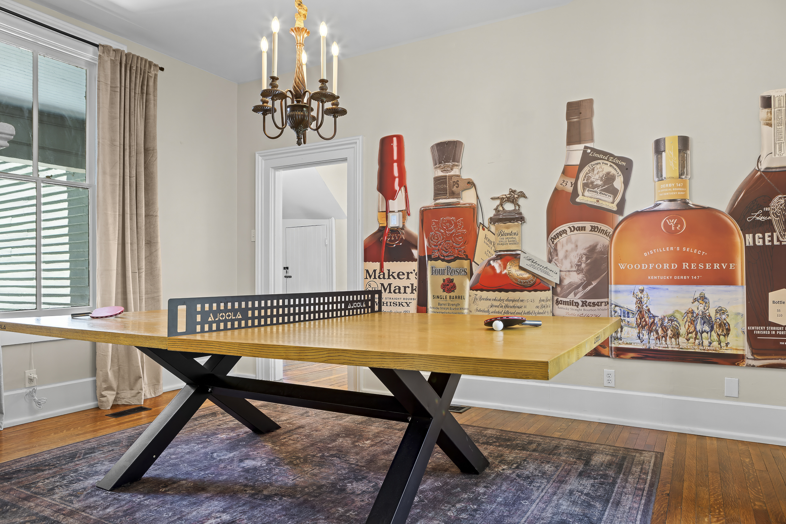 Ready to rally? The ping pong net goes up right under the bourbon bottle mural for maximum atmosphere.