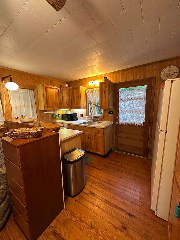 Fully stocked kitchen with everything you need—cookware, utensils, dishware, and coffee maker. Compact yet efficient, ready for cooking meals or enjoying takeout with ease.