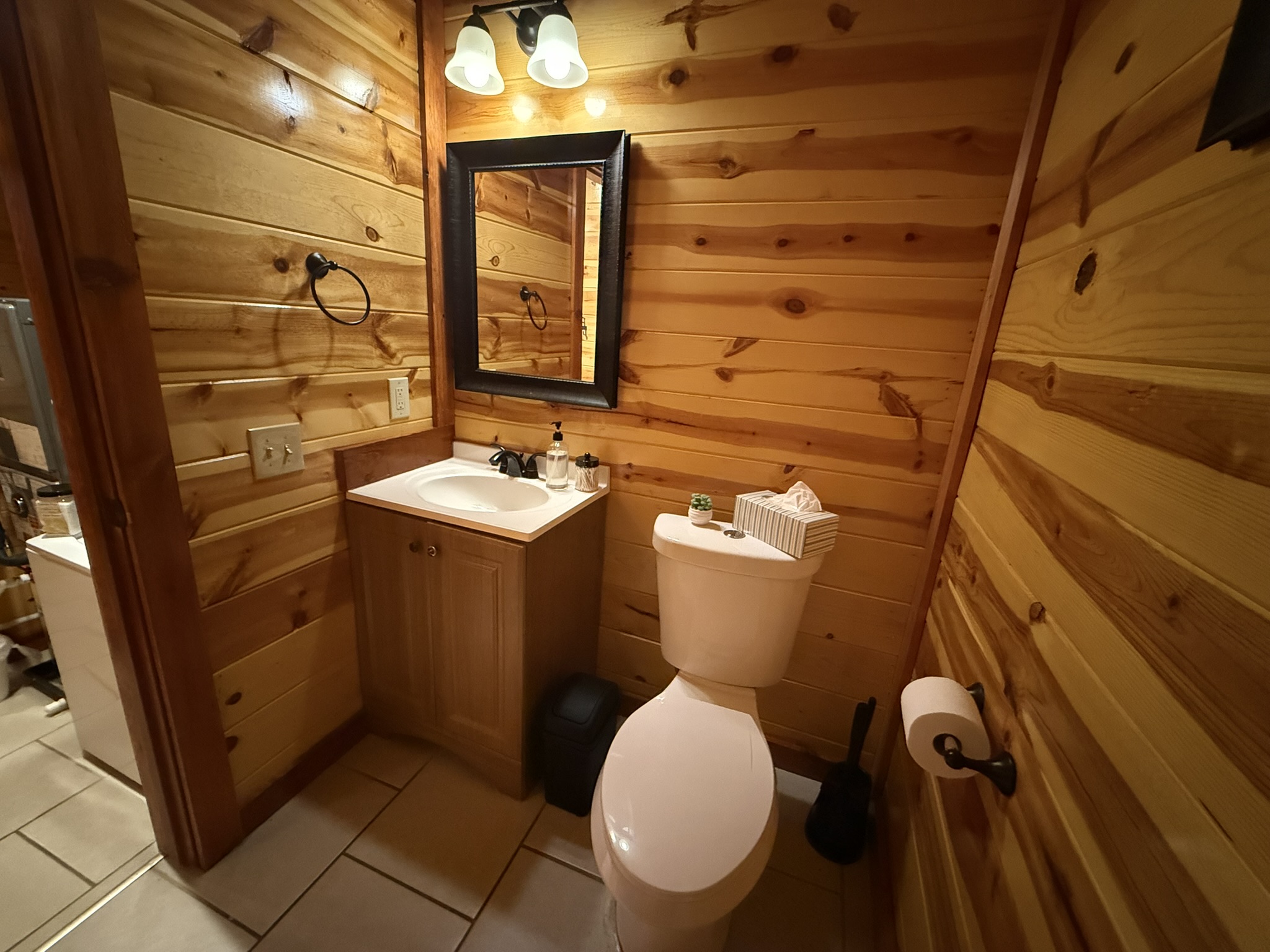 Located just down the hall from the pool room, this powder room adds extra convenience—because every guest appreciates plenty of well-appointed bathrooms.