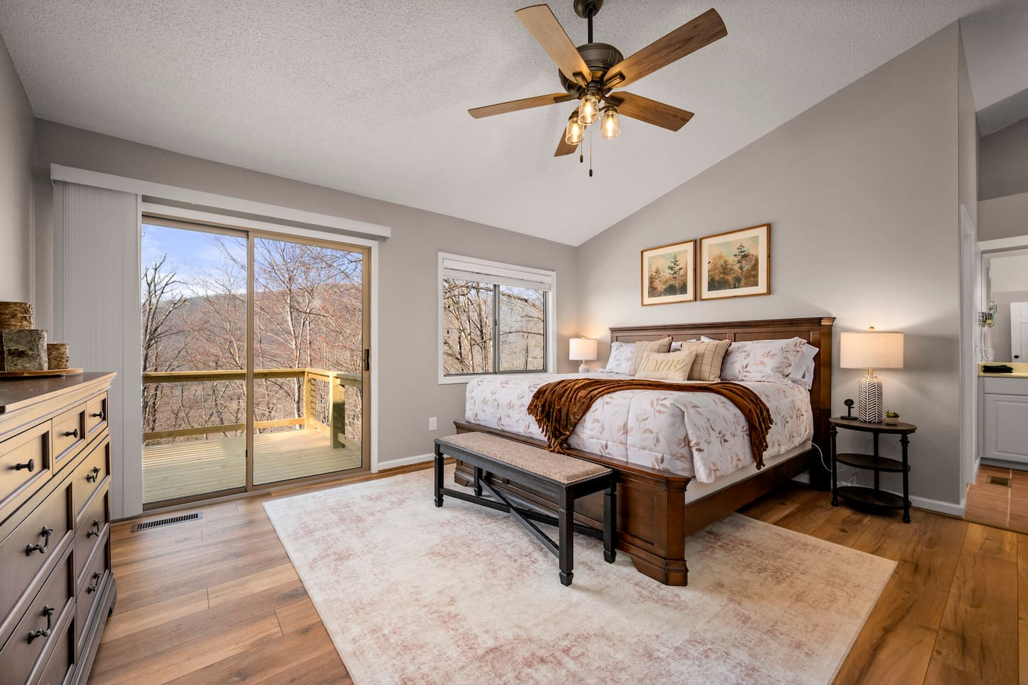Bedroom #1 on main level of home with en suite bathroom and deck access 