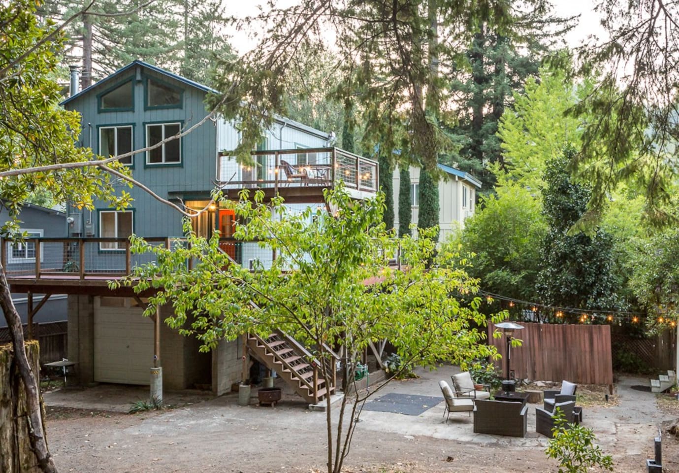 - Stylish multi level home with spacious decks for outdoor living  
- Ground level patio features cozy seating and a warm fire pit  
- Surrounded by towering trees for a serene, secluded retreat  