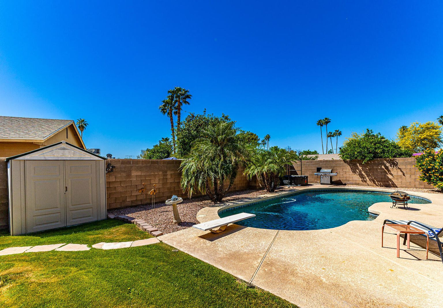 Enjoy an amazing backyard private pool with diving board and inflatable hot tub