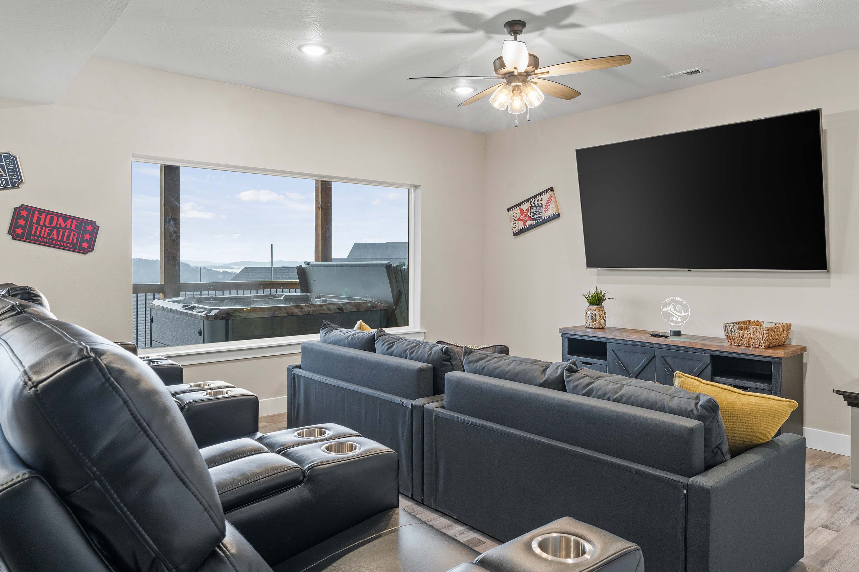 Lower-level Media Room has seating for eight. The powered recliners are perfect for watching your favorite movie or sport game on the large TV. The two sofas in front can be converted to twin beds.