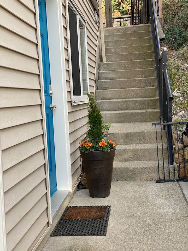 Looking down the sidewalk to the door to the suite in the left.