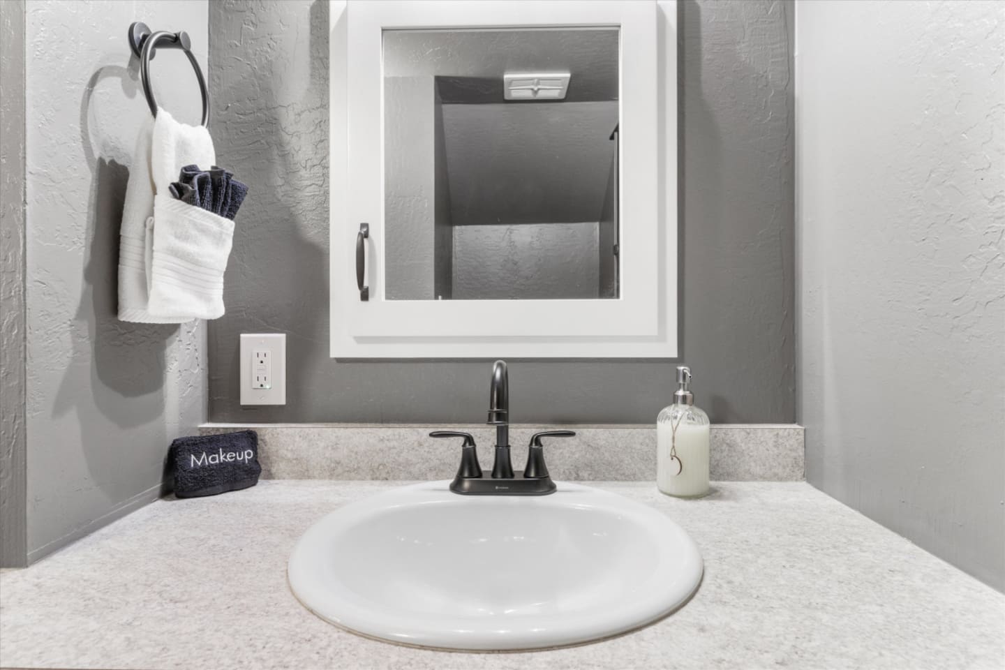 Bathroom vanity withcounter space, and simple essentials for getting ready.
