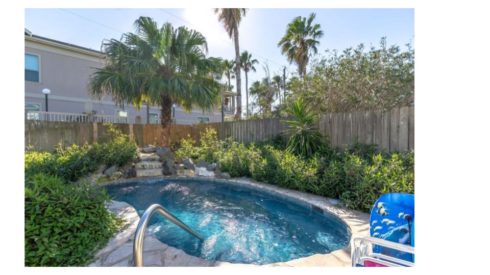 Our private tropical oasis awaits. Relax poolside under the covered patio with lounge chairs perfectly positioned for sun or shade. The heated 15-ft plunge pool features a soothing waterfall—ideal for cooling off after beach days.