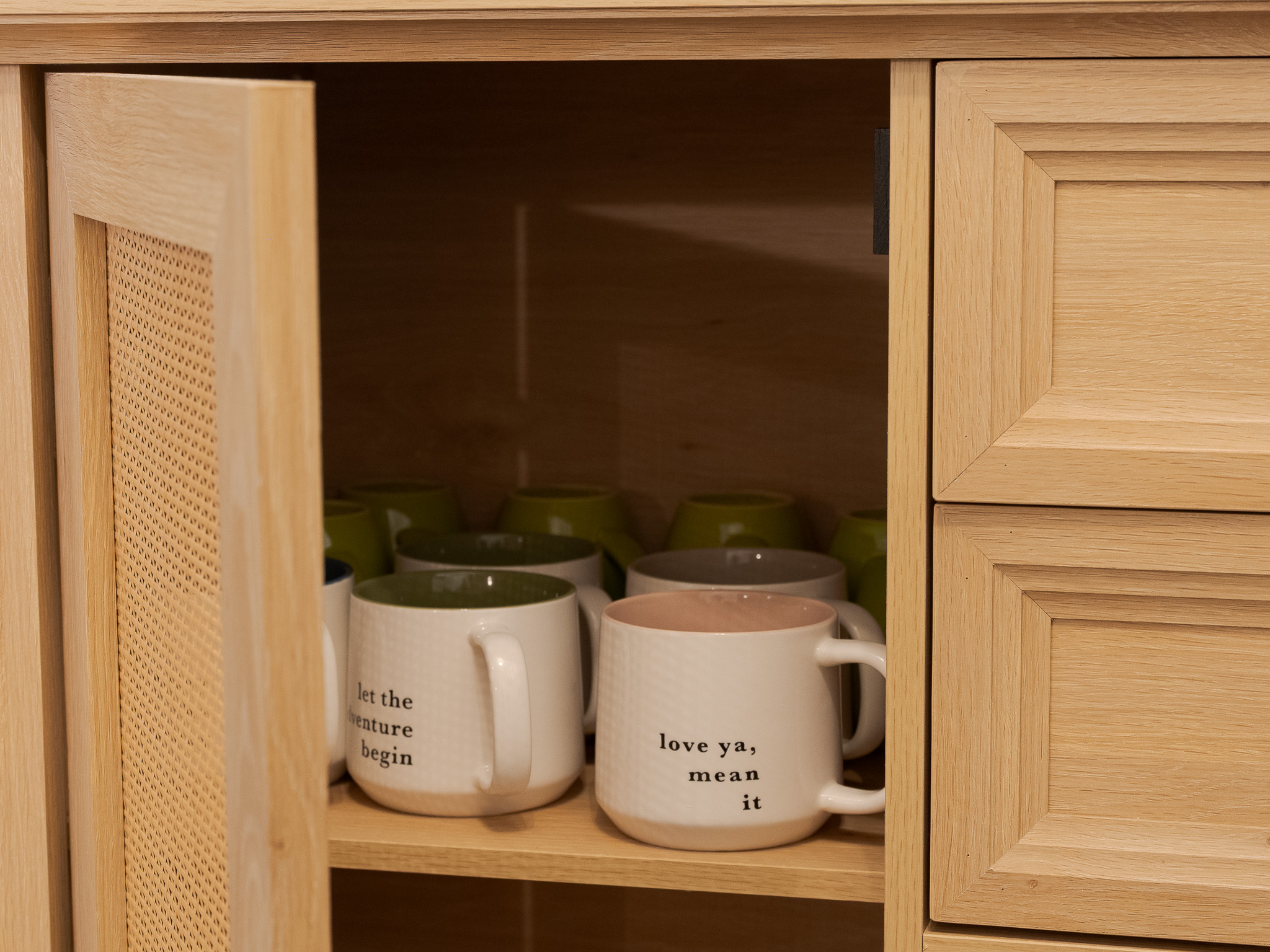 Access to coffee and tea cups, coffee and tea bags, and sugar are all in the cupboard below.