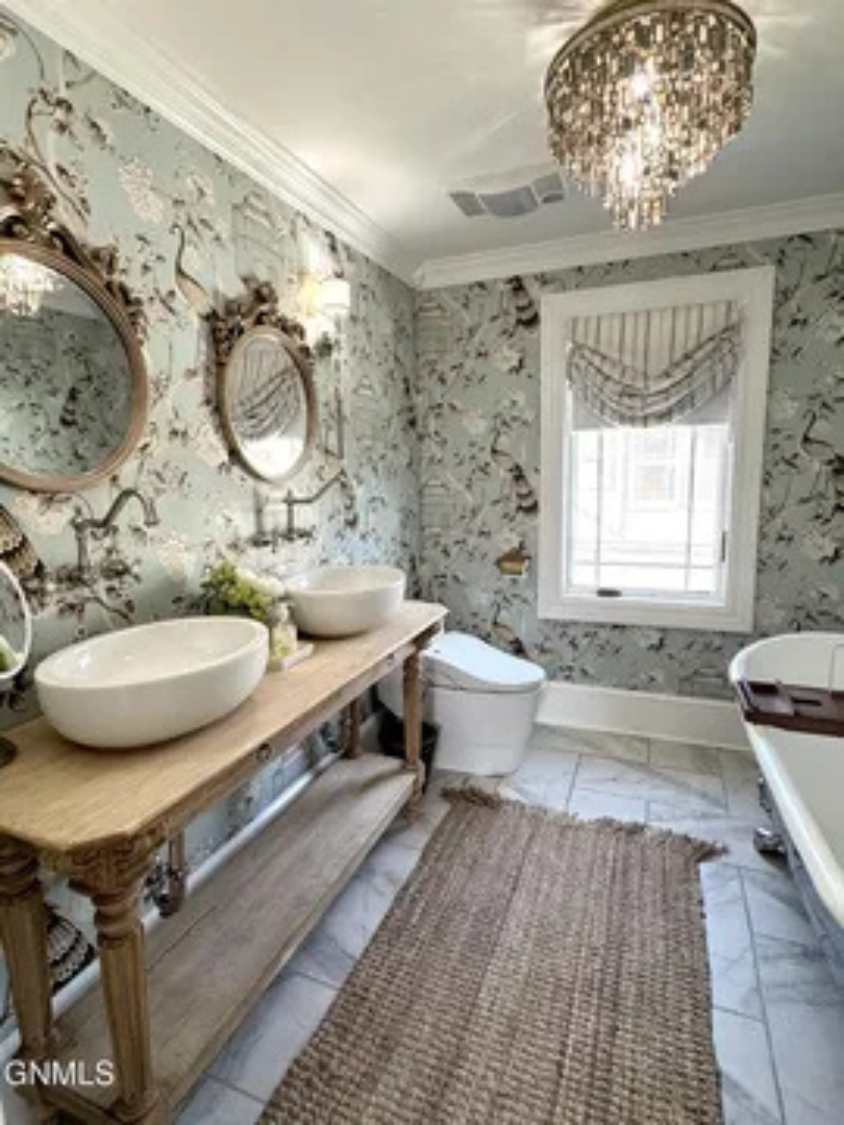 A bright bathroom setup with double sinks and a clean, relaxing feel.