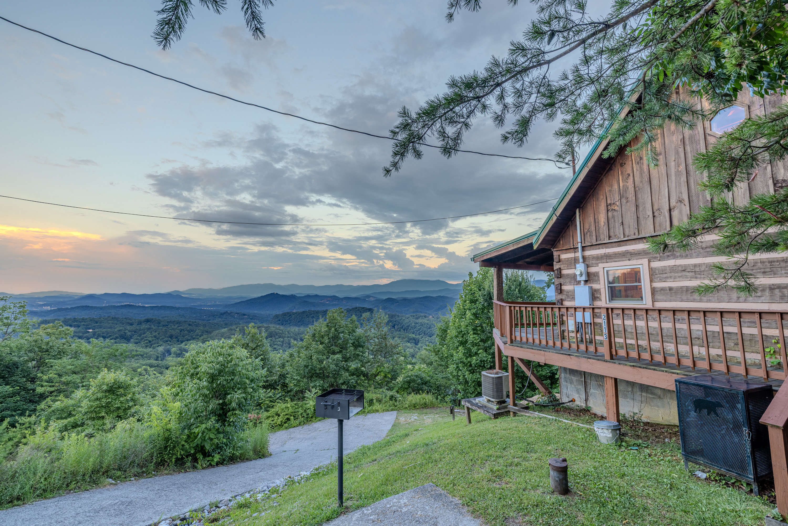 A mountain cabin surrounded by trees and open skies