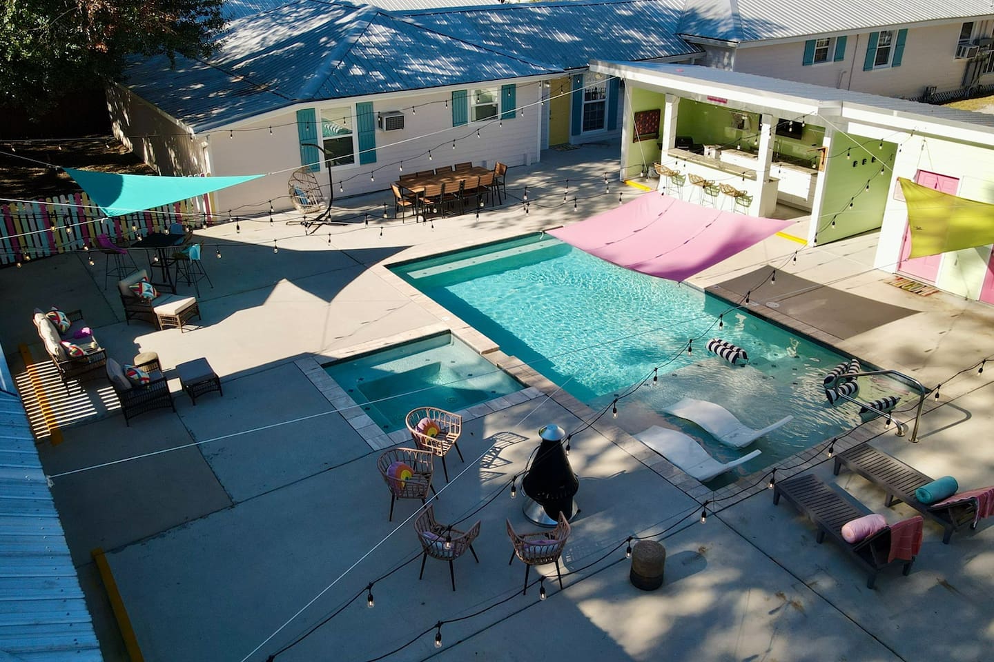 Elevated view of the pool courtyard with shaded loungers, social seating, and vibrant outdoor spaces.