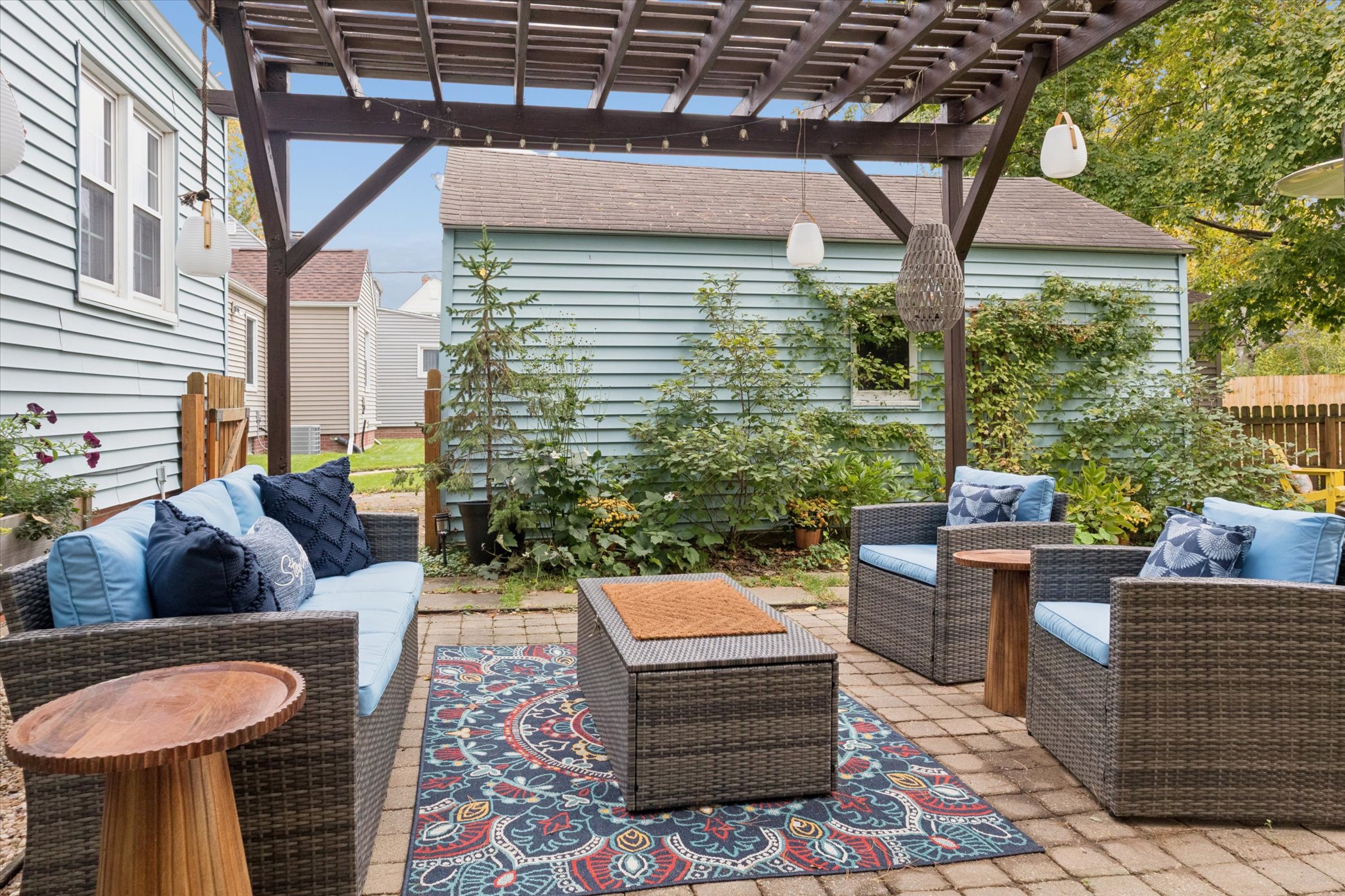Lounge in shaded comfort beneath the pergola—our cushioned backyard sofa sits steps from the herb garden and pizza oven. A cozy South Bend retreat near Notre Dame, perfect for alfresco fun.
