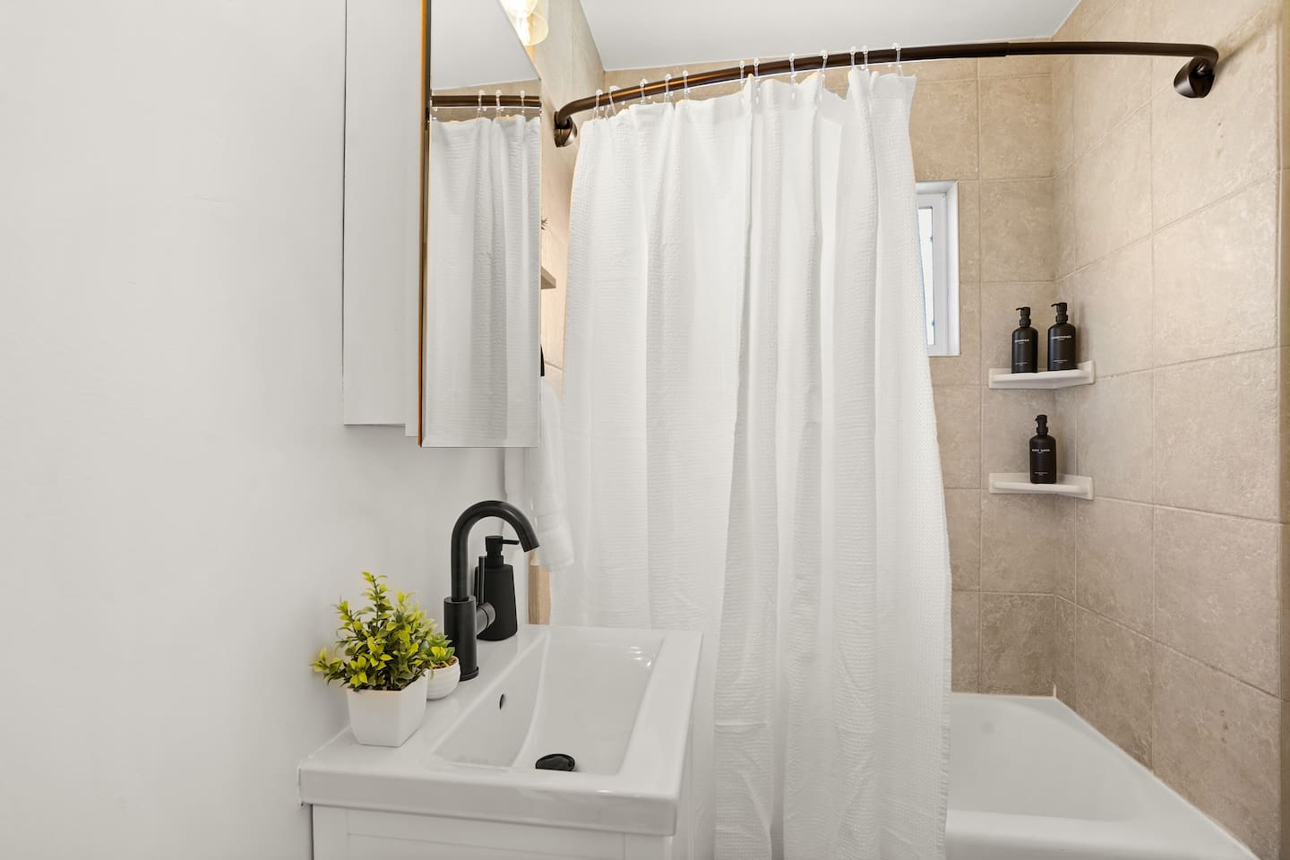 Modern bathroom with sleek finishes, fresh towels, and a clean, relaxing space to refresh during your stay.