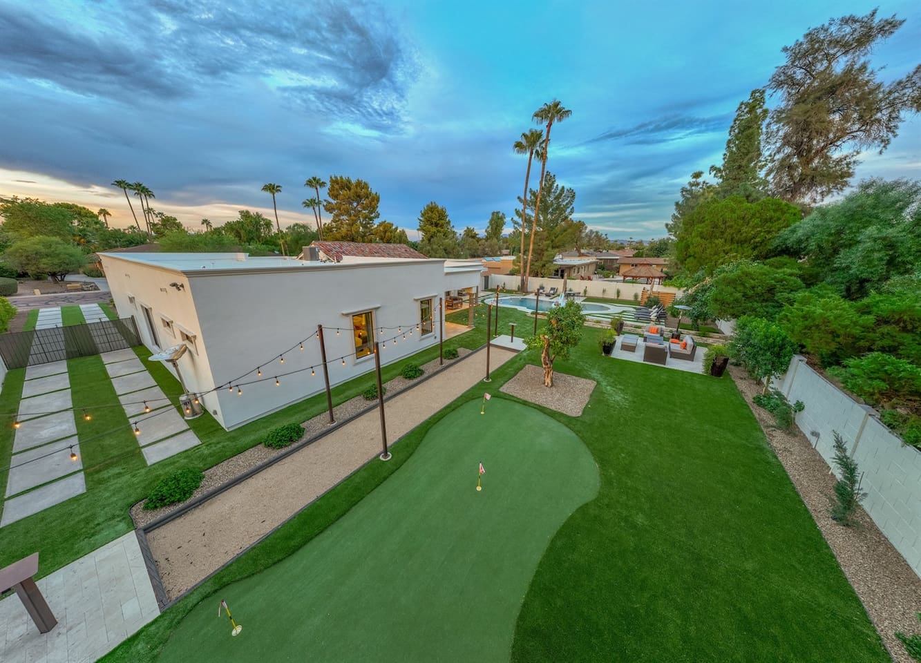 Play, relax, and unwind in our stunning outdoor space! Featuring a golf area, inviting pool, and charming lighted pathways, this is the ultimate retreat for your next getaway—reserve your stay!