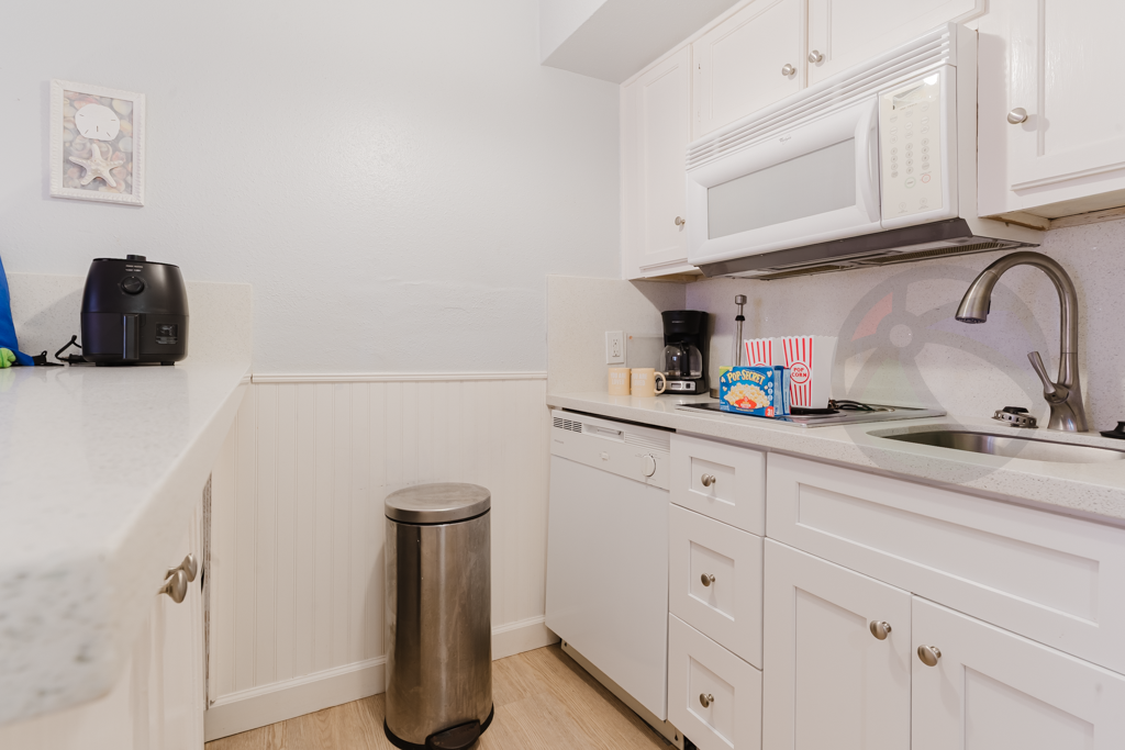 Kitchen with 2 burner cooktop, dishwasher, microwave and small refrigerator/freezer