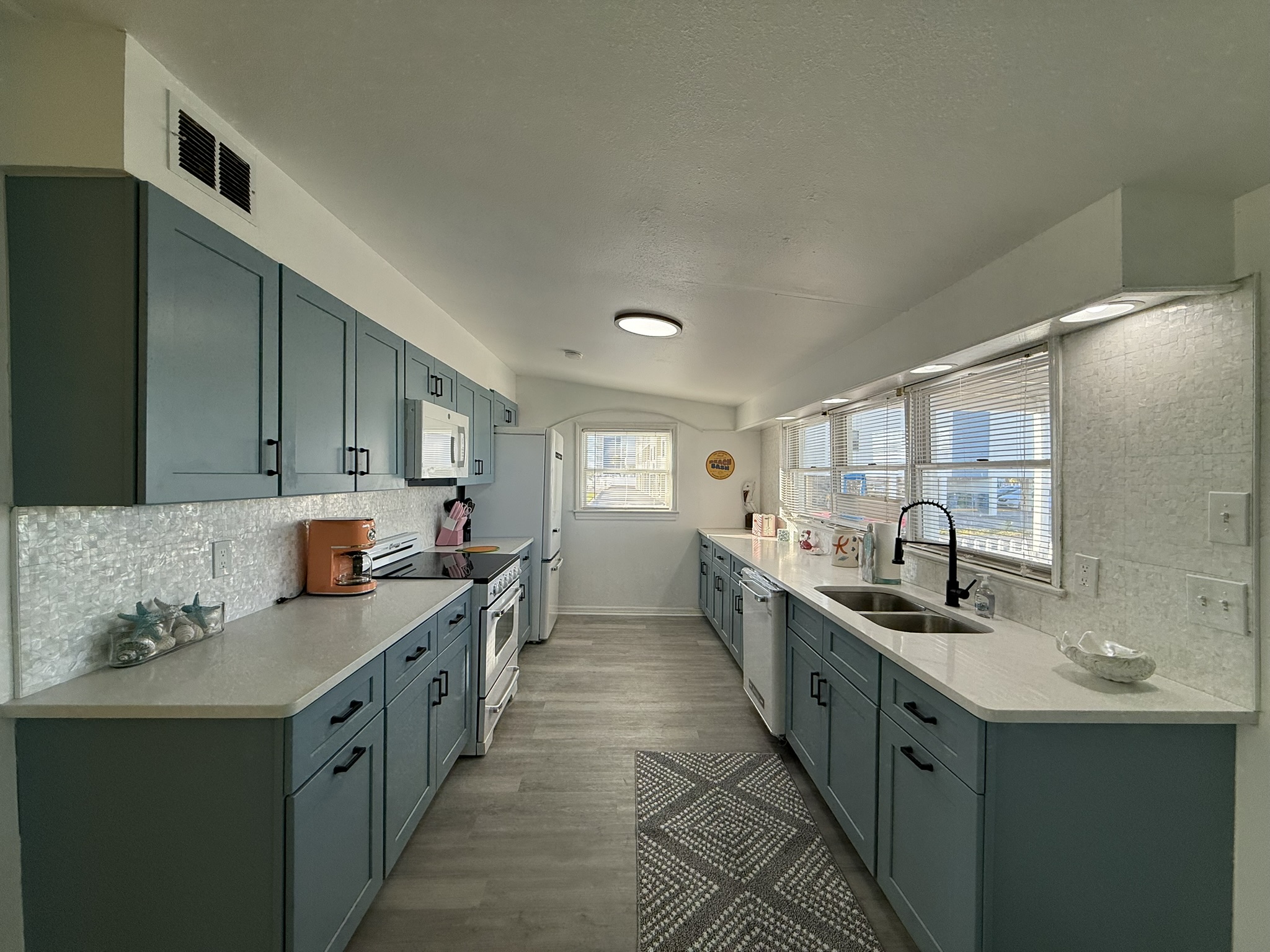 Blue Kitchen Cabinets with Retro Appliances and Mother of Pearl Backsplash!