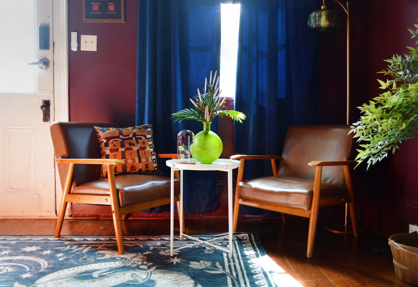 Sunlit reading nook with mid-century chairs and vintage décor inside this historic New  Orleans Airbnb. A cozy spot to sip coffee, relax, or recharge before exploring Bourbon Street and Frenchmen Street. 
